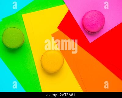 Sweet cake french macaroons, colorful macarons on colorful geometric background Birthday holiday party concept. Trendy pattern for decorative design. Stock Photo