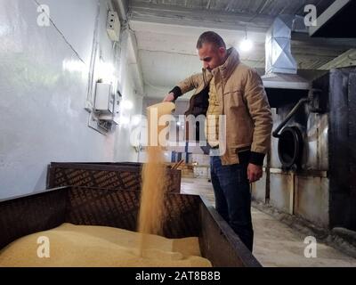 (200131) -- MOSUL, Jan. 31, 2020 (Xinhua) -- A worker makes Tahini at a factory in the city of Mosul, Iraq, on Jan. 30, 2020. Tahini, one of the famous productions of Iraq's northern city of Mosul, is a dense paste made from crushed sesame seeds. Iraqis enjoy Tahini on breakfast for its high calories. (Xinhua/Yaser Jawad) Stock Photo