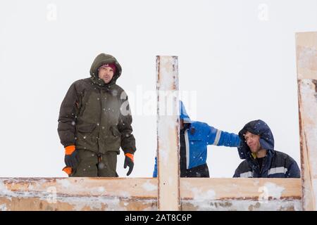 Two workers in overalls at a construction site Stock Photo