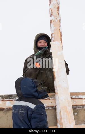 Two workers in overalls at a construction site Stock Photo