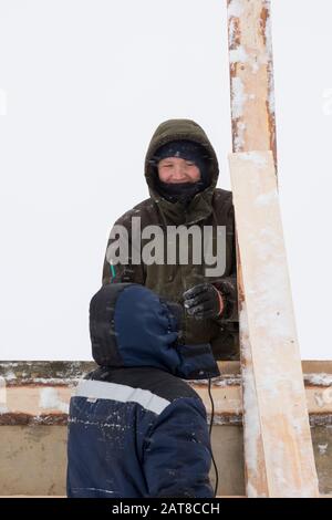 Two workers in overalls at a construction site Stock Photo
