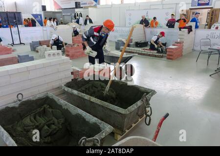 Young bricklayers perform a task of competition Stock Photo