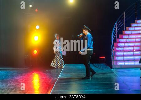 Beautiful man singing a song on stage Stock Photo