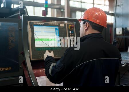 Industrial worker operating control panel system Stock Photo