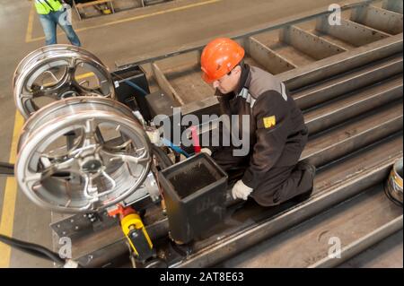 Worker with welder machine on factory Stock Photo