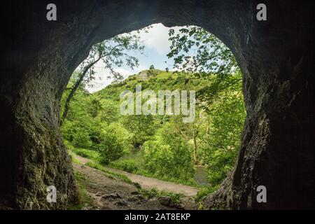 View from inside a cave at Dove Holes, Dove Dale, Peak District National Park, Derbyshire, England Stock Photo