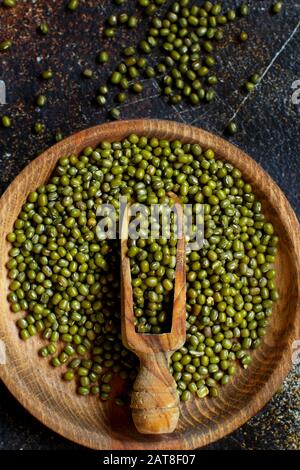 Dried mung beans with a spoon on a dark background  top view Stock Photo