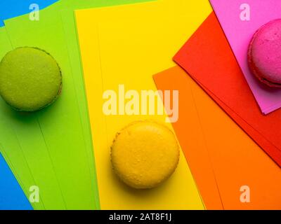 Sweet cake french macaroons, colorful macarons on colorful geometric background Birthday holiday party concept. Trendy pattern for decorative design. Stock Photo