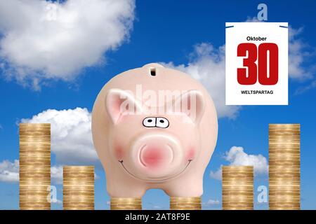 three piggybanks standing on Euro coins, composing with calendar sheet dated 30.10., World Savings Day Stock Photo