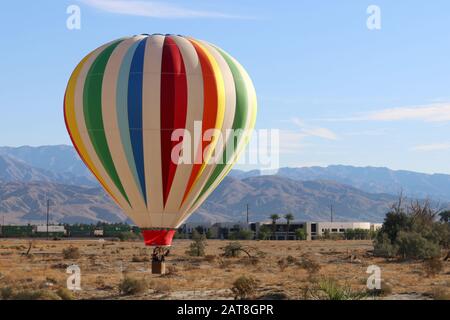 a hot air balloon landing in the desert Stock Photo