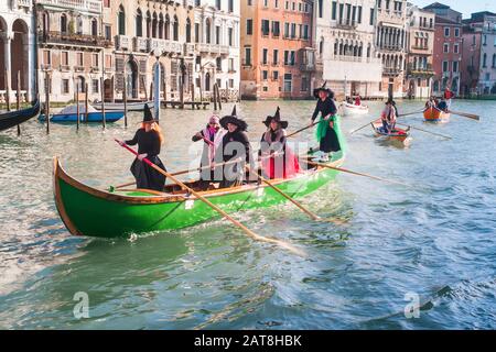 Venice, Italy - January 6 2014: Witches Rowing at Regatta of Befana in Venice, called Regata delle Befane. Members of Bucintoro Rowing Club Racing fro Stock Photo