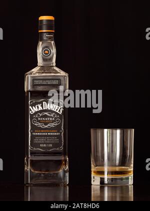 Lynchburg, Tennessee, USA - January 12 2020: Jack Daniels Sinatra Select Tennessee Whiskey in a Bottle and a Tumbler Glass on a Black Background. A Lu Stock Photo