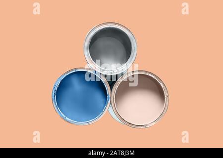 Color of the 2020 year. Three cans filled paint of ponder palette colors - trend of the 2020 year isolated on peach Quartz color background. Copy spac Stock Photo