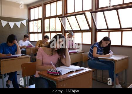 Teenagers in school classroom Stock Photo