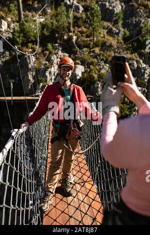Couple taking pictures on a bridge Stock Photo