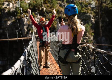 Couple taking pictures on a bridge Stock Photo