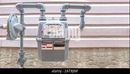 Residential urban natural gas meter measuring gas consumption, outside house gas meter Stock Photo