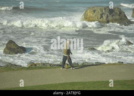 A man walking beside the ocean in south-west France, pasakdek Stock Photo