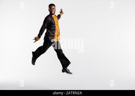 Afro american dancer on white background flies in jump. Dance school concept. Fitness concept, youth and health Stock Photo