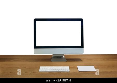 Modern personal computer on a wooden table with a white white screen for mock up and isolated white background. Stock Photo