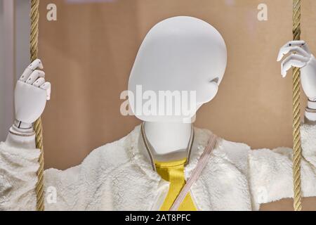 Baby mannequin in sweater and yellow shirt. Close up. Stock Photo