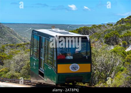 Tourists travel on the Flying Dutchman funicular from the viewing platform below the old Cape Point lighthouse, Cape Point National Park, South Africa Stock Photo