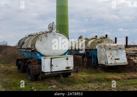 rusty and decaying milk tank trailers as they were used in the German Democratic Republic GDR Stock Photo