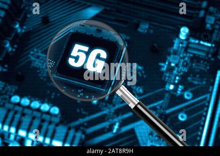 The concept of 5G network with magnifying glass on modern circuit board, high-speed mobile internet and new generation networks technology background Stock Photo