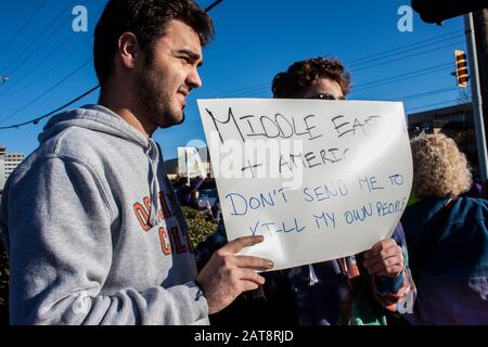 01-04-2020 Tulsa USA - Two boys who are part Middle Eastern and part American hold sign saying Don't send me to kill my own people Stock Photo