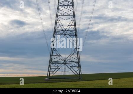 power transmission tower on background of cloudy sky Stock Photo