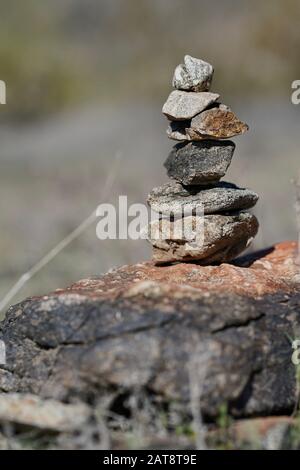 A stack of rocks known as a cairn marks the path for hikers Stock Photo ...