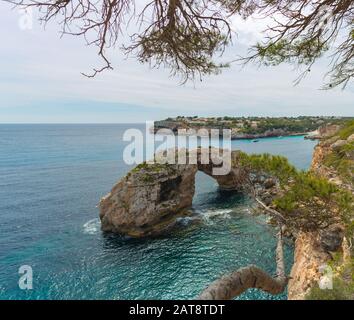 is pontas, natural stone arch on the coast of santanyi Mallorca. es pontas, arco de piedra natural en la costa de santanyi mallorca Stock Photo