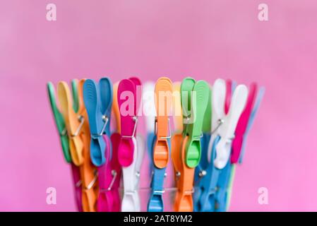 Multicolored clips for clothes, on pink background Stock Photo