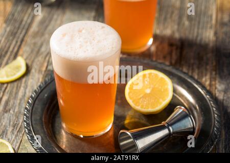 Refreshing Aperol Beer Shandy Cocktail with Lemon Stock Photo