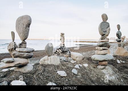 Figures of stones on the beach near the sea. Sea background and stone figures. Stock Photo