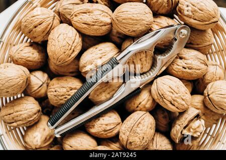 Nutcracker and walnuts in a large bowl Stock Photo