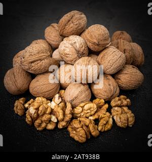 Walnut on over black slate stone background Stock Photo