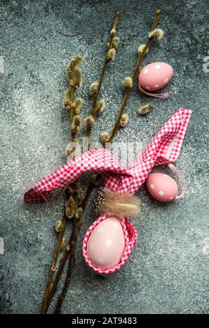 Easter holiday card concept with easter bunny concept with colored eggs on stone background with copy space Stock Photo