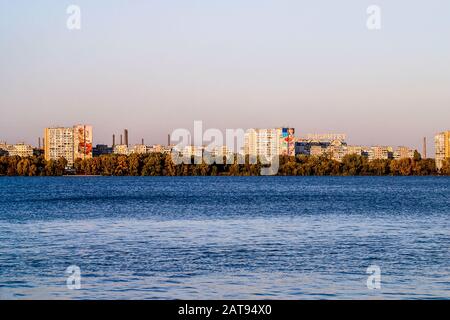 Left side of Dnipro city, Ukraine. Panoramic view of Dnipro river. Cityscape Housing estate Sunny with buildings. Mural artworks are painted by Artist Stock Photo