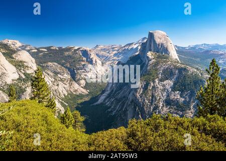 View of Half Dome from Glacier Point lookout in Yosemite National Park, California, USA on a sunny day. Stock Photo