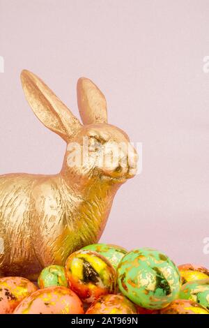 gold easter bunny rabbit  on pink background Stock Photo
