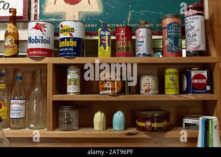 Bethel, Maine - September 28th, 2019: Display of vintage coffee cans, oil cans, bottles and various decorative objects at Steam Mill Antiques Stock Photo