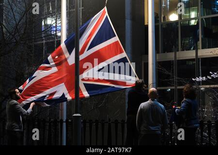 Brussels, Belgium. 31st Jan, 2020. Staff members take down the United Kingdom's flag from outside the European Parliament building in Brussels on Brexit Day. Credit: ALEXANDROS MICHAILIDIS/Alamy Live News Stock Photo