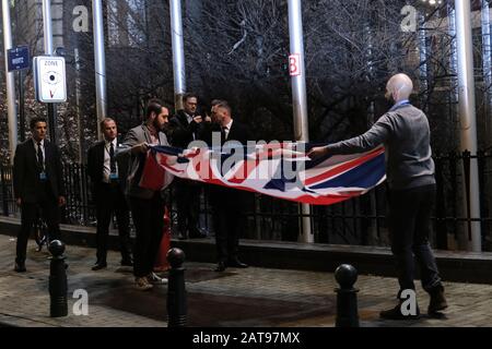 Brussels, Belgium. 31st Jan, 2020. Staff members take down the United Kingdom's flag from outside the European Parliament building in Brussels on Brexit Day. Credit: ALEXANDROS MICHAILIDIS/Alamy Live News Stock Photo