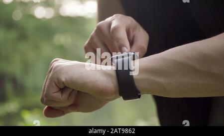 Making various gestures with a finger on a touch screen of a smart watch wearable device. Stock Photo