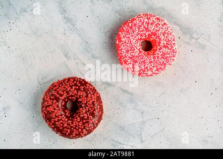 Delicious chocolate donuts on a gray concrete surface. Stock Photo