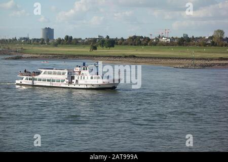 A small river cruise boat on the Rhine river in Dusseldorf, Germany. Stock Photo