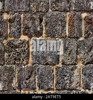 Rustic brick wall background texture deeply textured with ancients bricks and mortar.  12x12 digital paper for graphic design projects, Stock Photo