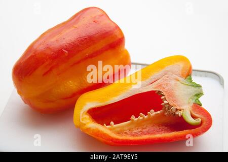 Striped Holland bell peppers are red and yellow vegetables in this food still life. Stock Photo