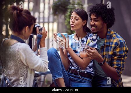 young smiling couple looking to camera and posing for photographer outdoor Stock Photo